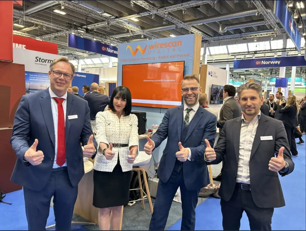 Team members at the Wirescan exhibition stand